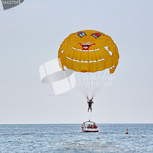 Image of Parasailing in a blue sky near sea beach