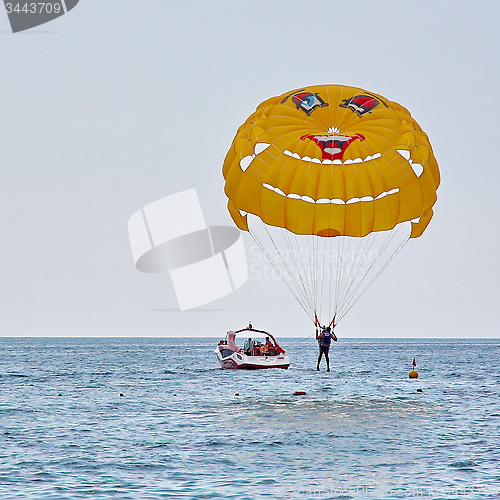 Image of Parasailing in a blue sky near sea beach