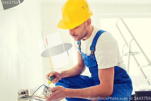 Image of builder with tablet pc and equipment indoors