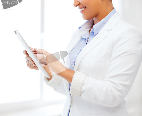 Image of businesswoman with tablet pc in office