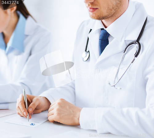 Image of doctor and nurse writing prescription paper