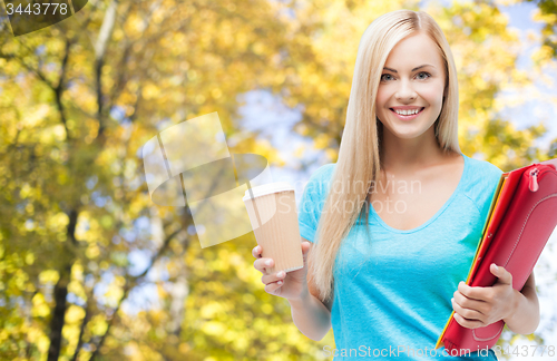 Image of smiling student girl with folders and coffee cup