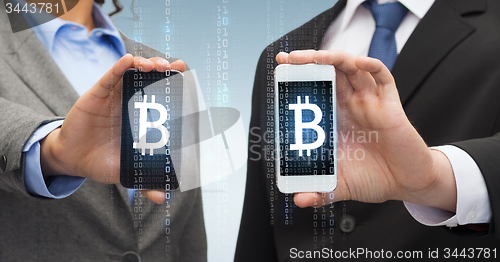 Image of businessman and businesswoman with smartphones