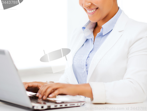 Image of businesswoman with laptop in office