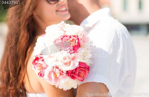 Image of close up of couple with bunch flowers in city