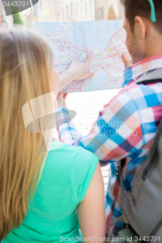 Image of close up of couple with map and backpack in city
