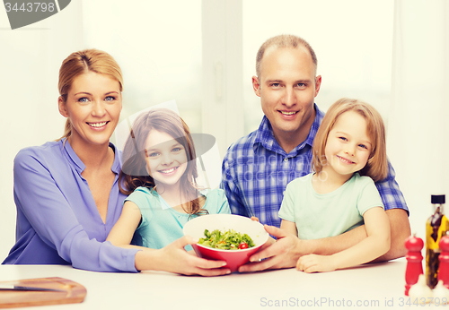 Image of happy family with two kids with salad at home