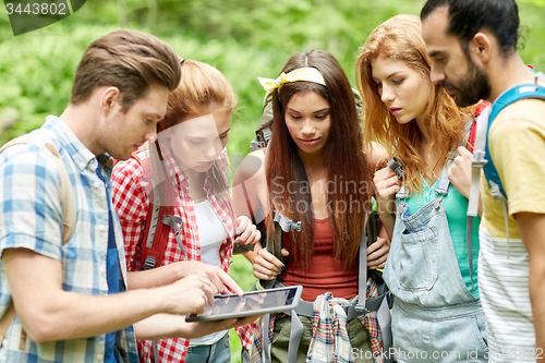 Image of friends with backpacks and tablet pc hiking