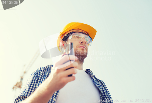 Image of builder in hardhat with radio