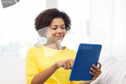 Image of happy african american woman with tablet pc