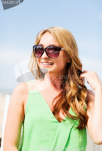 Image of girl in shades in cafe on the beach