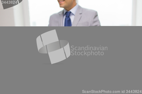 Image of close up of businessman with laptop and papers