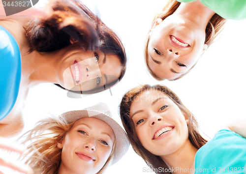 Image of faces of girls looking down and smiling