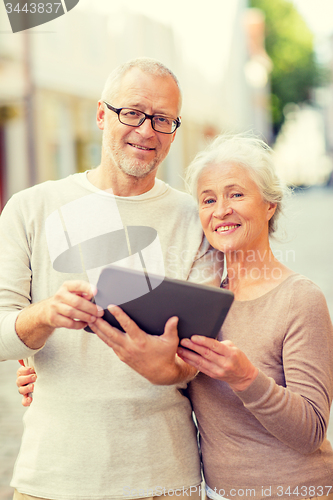 Image of senior couple photographing on city street