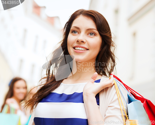 Image of beautiful woman with shopping bags in the ctiy