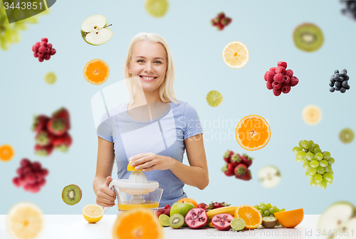 Image of smiling woman squeezing fruit juice