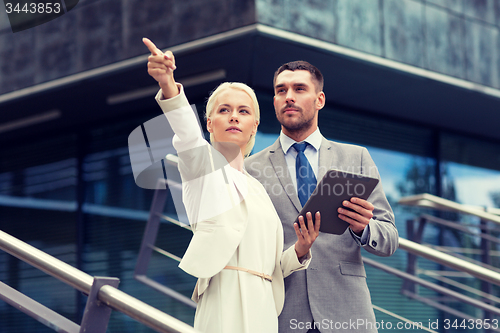 Image of serious businessmen with tablet pc outdoors