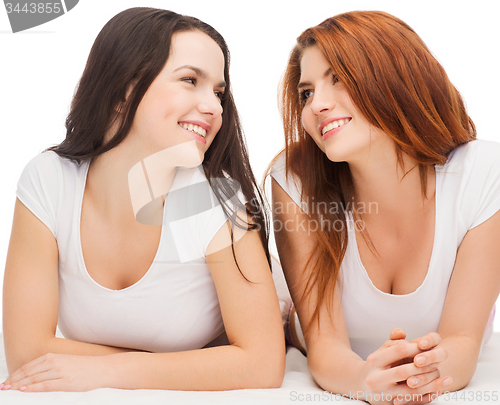 Image of two laughing girls in white t-shirts