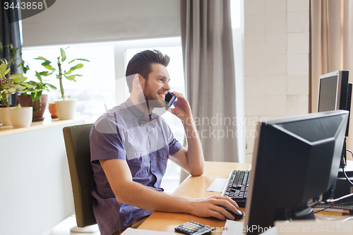 Image of happy creative male worker calling on smarphone