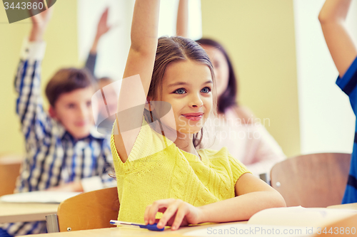 Image of group of school kids with notebooks in classroom