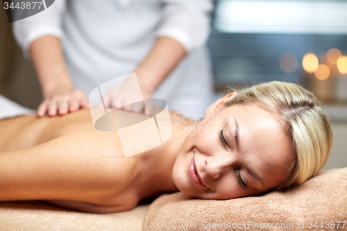 Image of close up of woman lying and having massage in spa