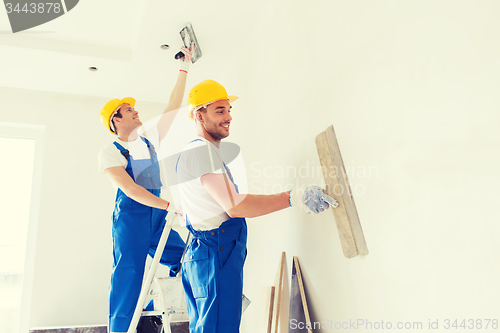 Image of group of builders with tools indoors