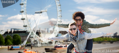 Image of happy teenage couple having fun over london