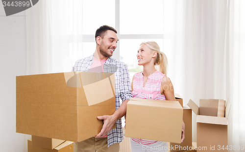 Image of couple with big cardboard boxes moving to new home