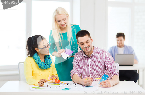 Image of smiling interior designers working in office