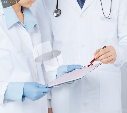 Image of nurse and male doctor holding cardiogram