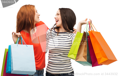 Image of two smiling teenage girls with shopping bags