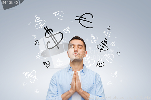 Image of happy man praying god for money