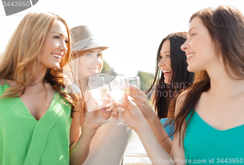 Image of smiling girls with champagne glasses
