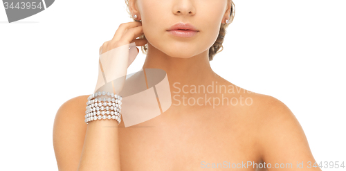 Image of woman with pearl earrings and bracelet