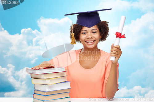 Image of happy african bachelor girl with books and diploma