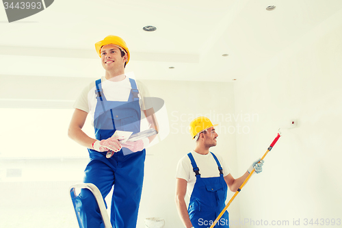 Image of group of builders with tools indoors