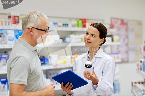 Image of pharmacist with tablet pc and senior man