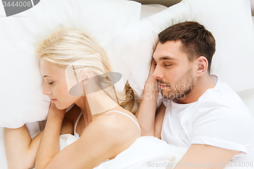 Image of happy couple sleeping in bed