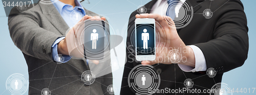 Image of businessman and businesswoman with smartphones