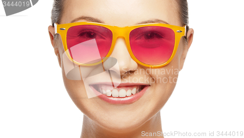 Image of smiling teenage girl in pink sunglasses