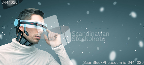 Image of man with futuristic 3d glasses and sensors