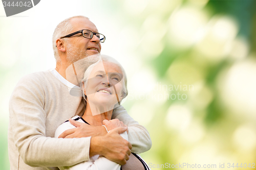 Image of happy senior couple over green natural background