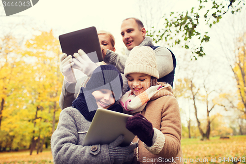 Image of happy family with tablet pc in autumn park