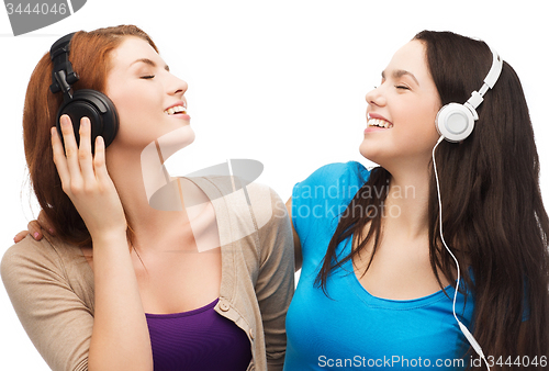 Image of two smiling teenagers with headphones