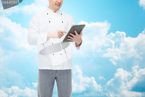 Image of close up of happy male chef cook holding tablet pc