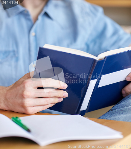 Image of close up of student reading book at school