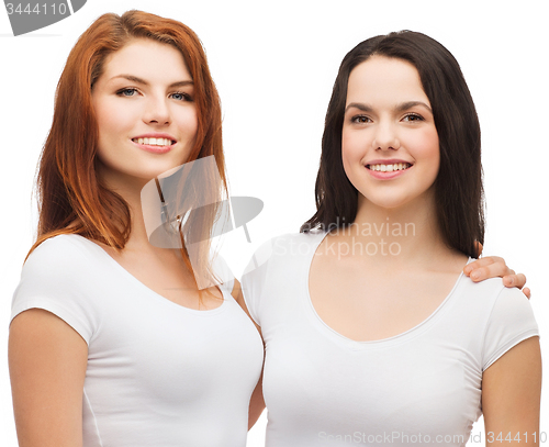 Image of two laughing girls in white t-shirts hugging