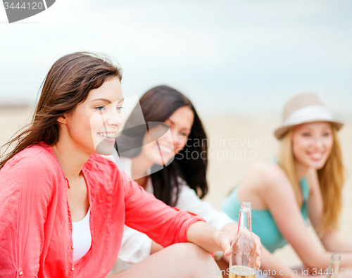 Image of girls with drinks on the beach