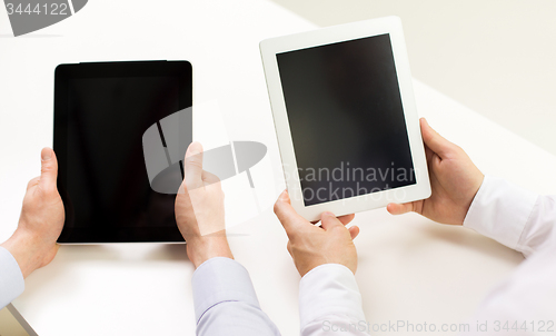 Image of close up of businessman hands with tablet pc