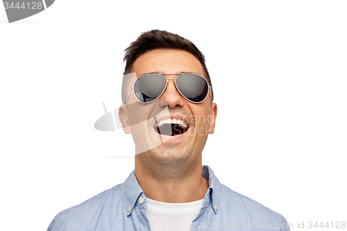 Image of face of smiling man in shirt and sunglasses
